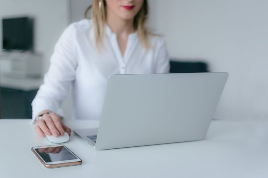 woman using silver laptop